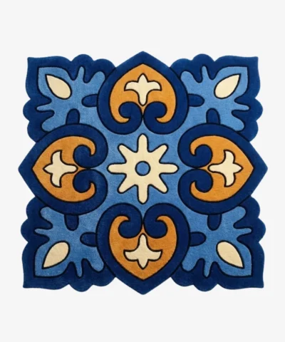 Top down view of the Azure Heirloom square rug featuring a traditional tile inspired geometric pattern with ornate blue and gold motifs and scalloped edges.