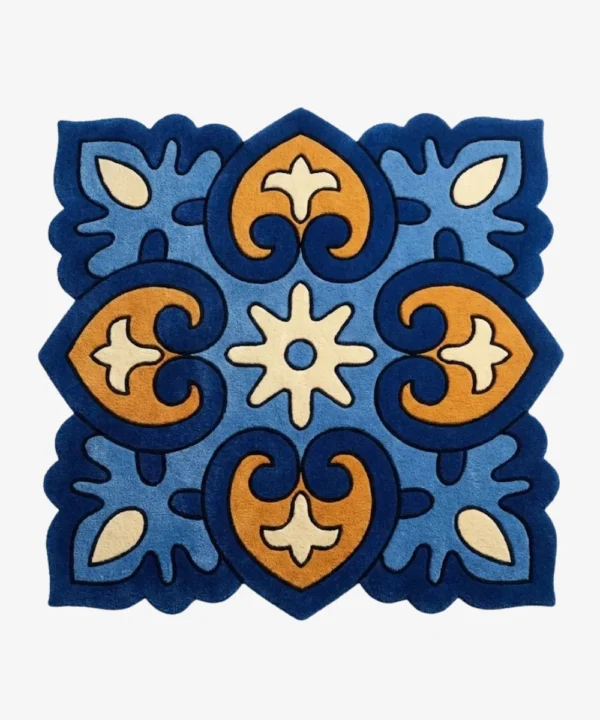 Top down view of the Azure Heirloom square rug featuring a traditional tile inspired geometric pattern with ornate blue and gold motifs and scalloped edges.