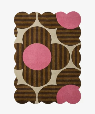Top down view of the Dusky Bloom rug featuring a bold 1970s inspired floral pattern with brown striped petals and vibrant pink circles on a cream background.