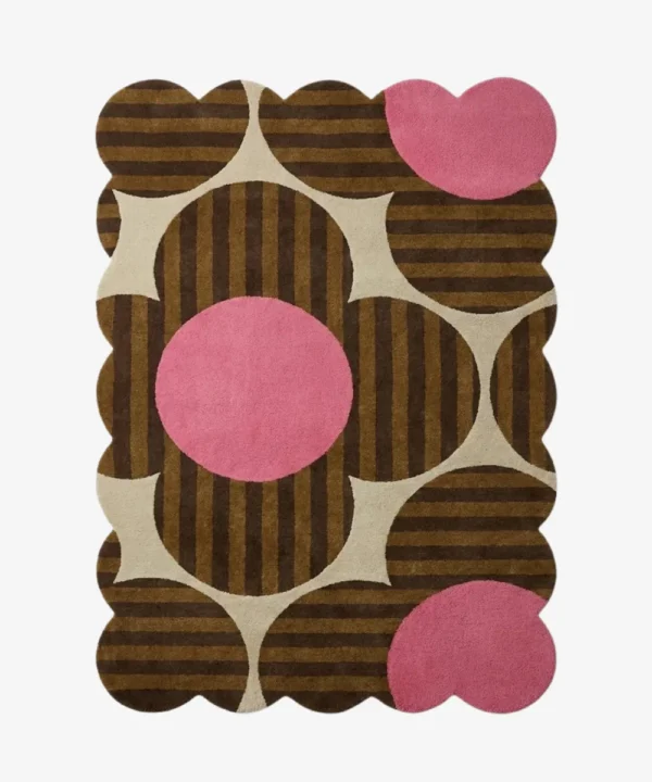 Top down view of the Dusky Bloom rug featuring a bold 1970s inspired floral pattern with brown striped petals and vibrant pink circles on a cream background.