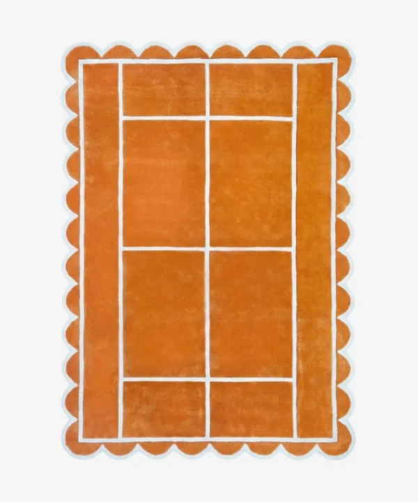 Top down view of the Hearth Grid rug featuring a vibrant terracotta orange wool background with a white geometric line pattern resembling a tennis court layout, finished with playful scalloped edges.
