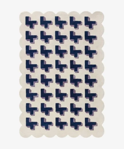 Top-down view of the Midnight Surge rug against a white background, featuring a repeating 3D geometric pattern of dark blue crosses with lavender shadows on a solid cream background, framed by a continuous cream scalloped border.