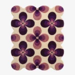 Top down view of the Mulberry Petal rug featuring a retro 70s inspired floral pattern with bold purple and lilac flower motifs on a cream wool background.