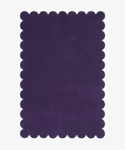 Top down flat lay of the Nightberry rug featuring a rich deep purple color and decorative scalloped borders isolated on a white background.