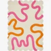 Top down view of the Peach Giggle rug featuring a soft cream background with playful abstract squiggly lines in bright pink and orange.