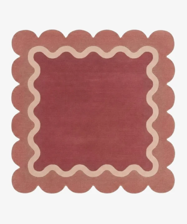 Top down view of the Rose Whisper Square rug featuring a deep rose central field framed by a wavy cream line and a soft pink scalloped border.
