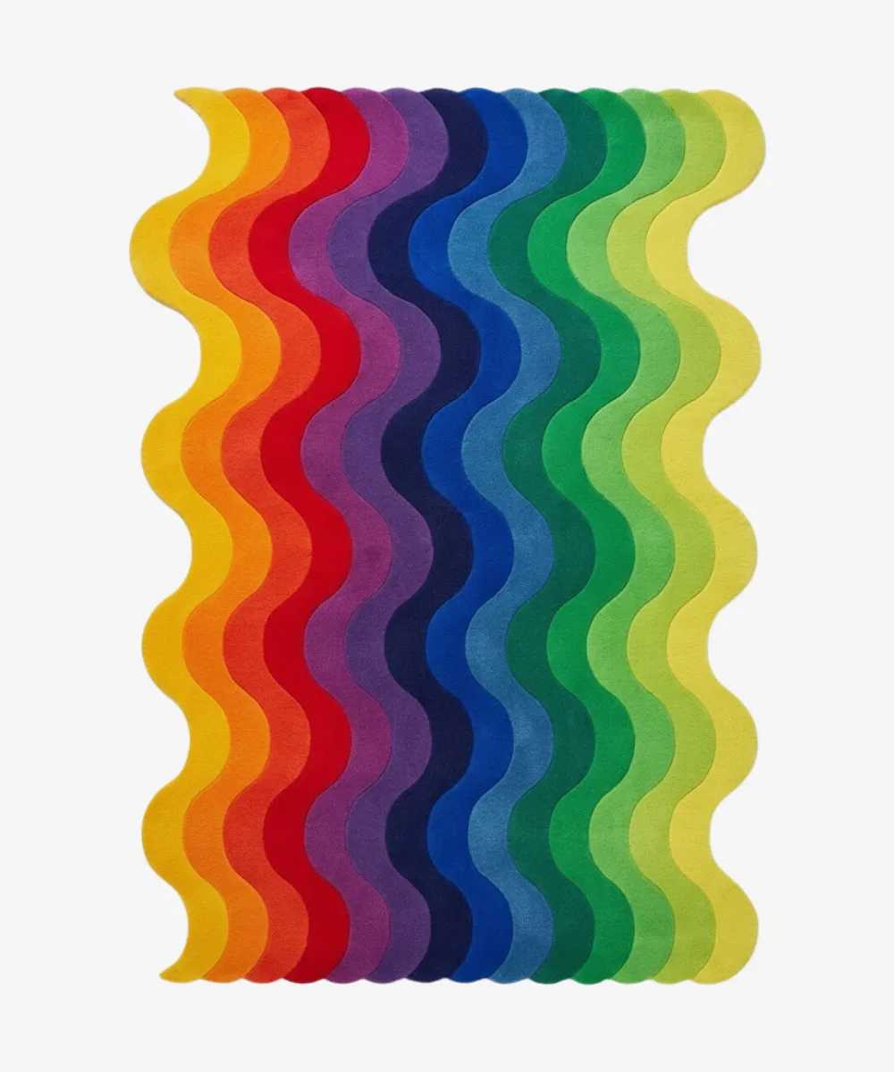 Top down view of a statement piece from the ScallopedRugs Multicolor collection featuring a vibrant rainbow gradient with vertical wavy stripes and a custom irregular scalloped shape.