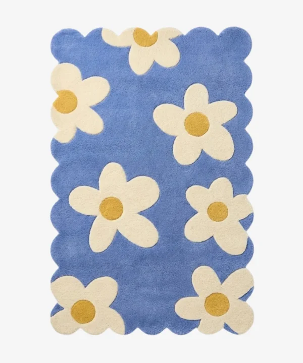 Top down view of the Sea Tonic rug featuring a fresh blue background with large white daisy motifs and yellow centers.