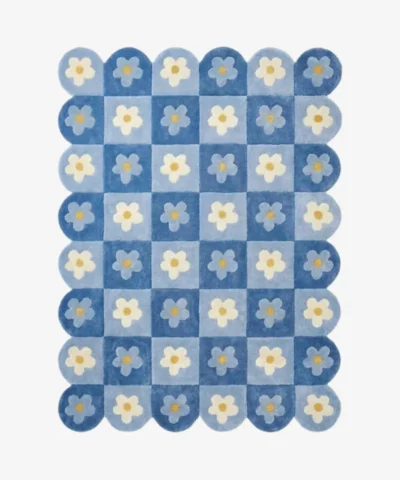 Top down view of the Sky Carousel rug featuring a playful checkerboard pattern in dark and light blue with white daisy flowers in every square.