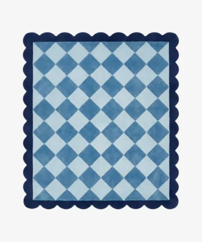 Top down view of the Slate Haven rug featuring a classic diamond checkerboard pattern in soft slate blue and light blue tones, framed by a deep blue scalloped border.