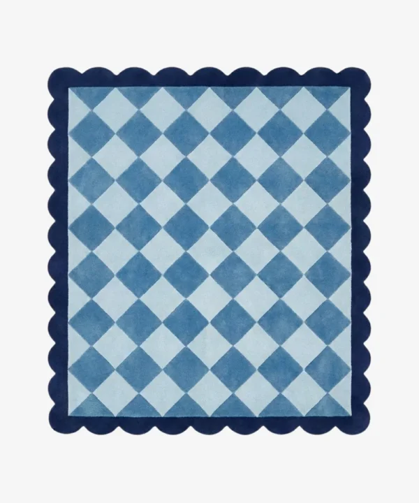 Top down view of the Slate Haven rug featuring a classic diamond checkerboard pattern in soft slate blue and light blue tones, framed by a deep blue scalloped border.