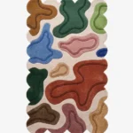 Top down view of the Terra Pebble rug featuring a cream background with distinct organic abstract shapes in terracotta blue green and pink.