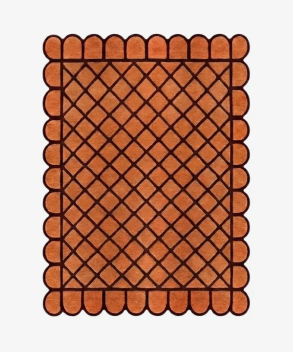 Top down view of the Terracotta Grid rug featuring a warm orange wool background with a bold dark brown square grid pattern and custom scalloped edges.