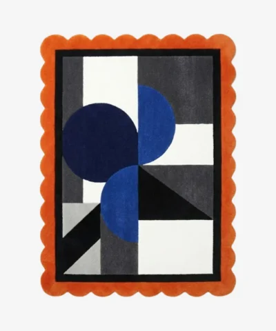 Top view of the Noctra Apex hand tufted wool rug featuring a playful orange scalloped border surrounding a modern geometric composition of navy blue circles and charcoal grey blocks on a cream background.