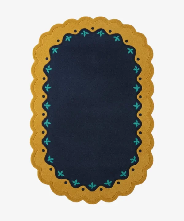 Top down view of the Royal Indigo rug featuring a deep navy blue center framed by a mustard gold scalloped border with delicate teal floral accents.