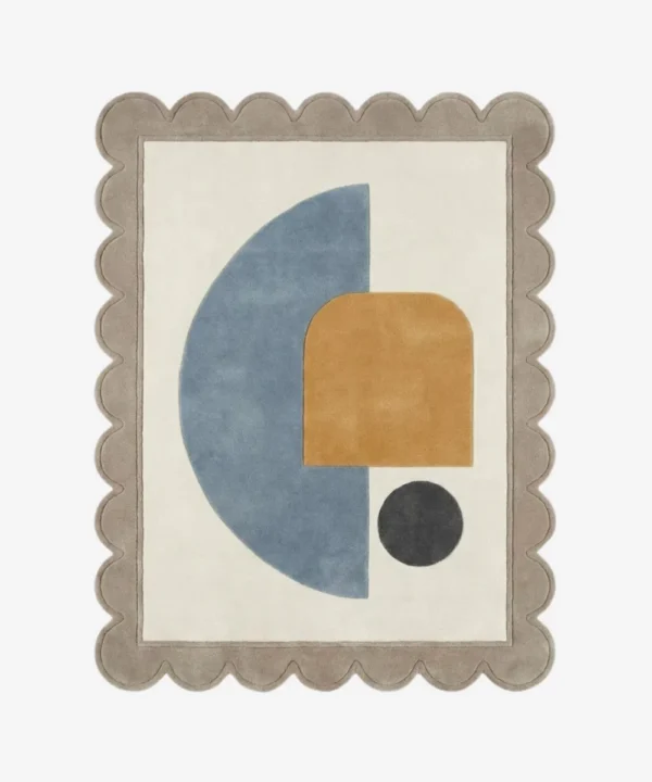 Top down view of the Still Shore rug featuring a calming abstract geometric design with a large blue semi-circle and ochre arch accent on a cream wool background, finished with custom scalloped edges.