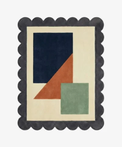 Top down view of the Stone Leaf rug featuring a calming geometric design with earthy stone grey and sage green accents on a plush wool background, finished with custom scalloped edges.