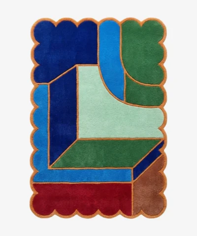 Top down view of the Sunroom Courtyard rug featuring a vibrant geometric pattern reminiscent of sunny courtyard tiles in shades of yellow, cream, and terracotta, finished with a custom scalloped edge.