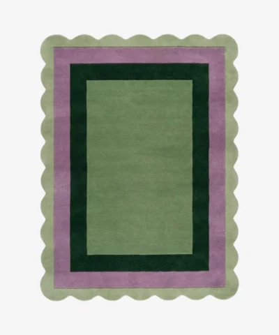 Top-down view of the Trimmed Forest rug against a white background, featuring a classic rectangular design with concentric color-block borders in light green, muted purple, and dark forest green, wrapped around a solid light green center and framed by a continuous light green scalloped edge.