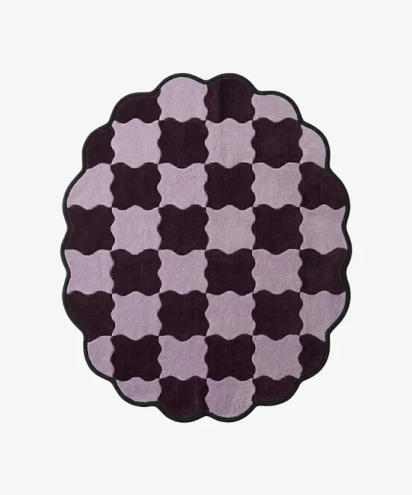Top-down view of the round Amora Weave rug, featuring a whimsical wavy checkerboard pattern in alternating shades of light lilac and deep plum purple, framed by a continuous black scalloped border.