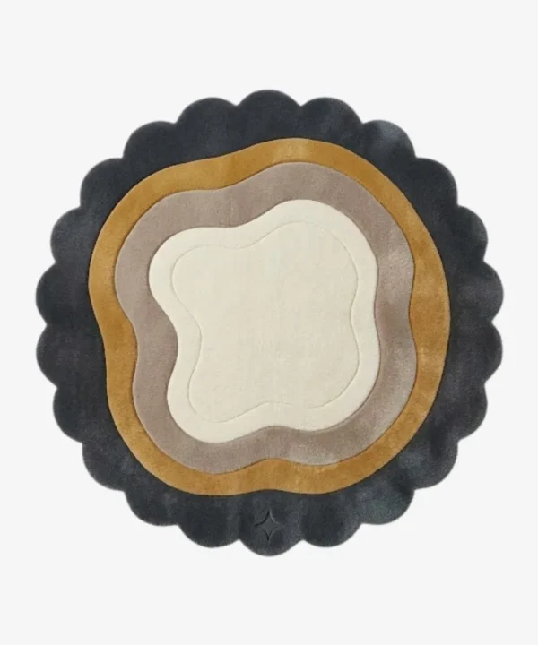 Top-down view of the circular Aurelith Flow rug, featuring a cream organic center surrounded by wavy concentric layers in soft taupe and mustard yellow, all framed by a thick, dark charcoal scalloped border.