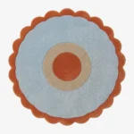 Top-down view of the Aurora Ring round rug, featuring a rust orange center circle, a cream middle ring, a wide light blue outer field, and a rust orange scalloped border.