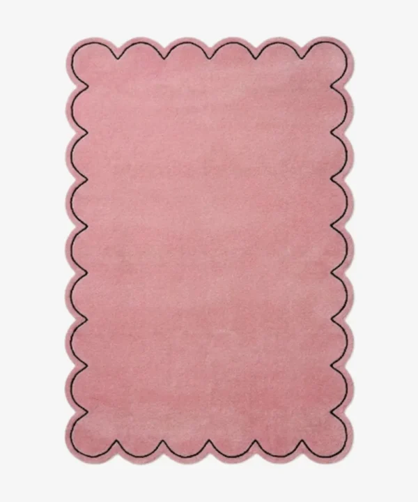 Top-down view of the rectangular Blush Halo rug, featuring a solid soft pink field with a continuous scalloped border and a thin black line outlining the wavy edge.