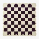 Top-down view of the square Porcelain Rhythm rug, featuring a classic checkerboard pattern in deep plum purple and cream, framed by a matching continuous cream scalloped border.