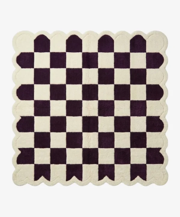 Top-down view of the square Porcelain Rhythm rug, featuring a classic checkerboard pattern in deep plum purple and cream, framed by a matching continuous cream scalloped border.