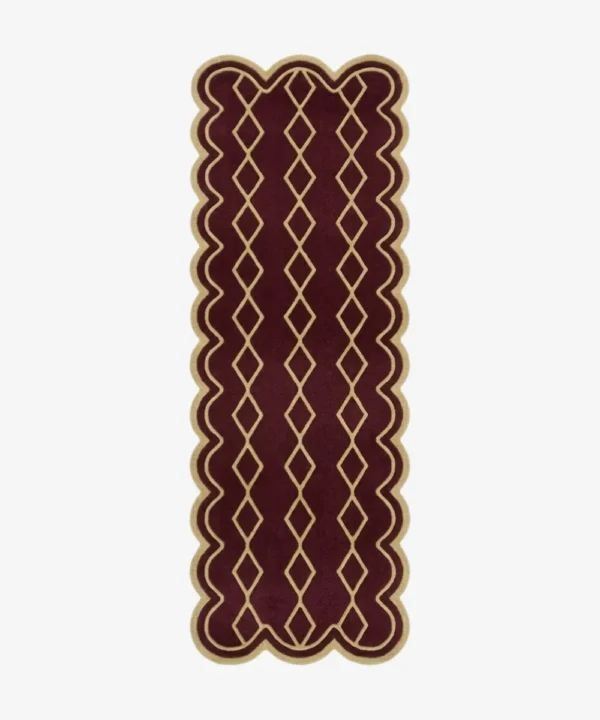 Top down view of the hand-tufted Solyvr Axis Runner Rug featuring a rich burgundy background, a gold geometric diamond pattern, and scalloped edges.