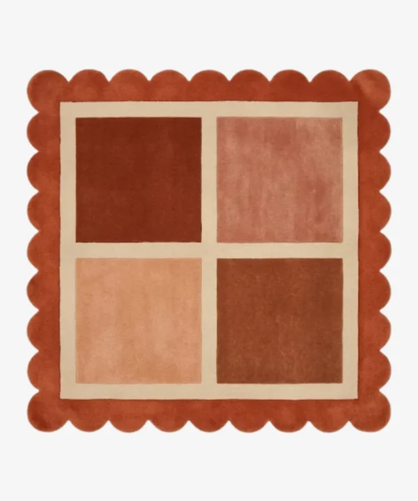 Top-down view of the square Sunset Panel rug featuring a cream grid with four color-blocked squares in shades of rust and peach, framed by a thick rust orange scalloped border.