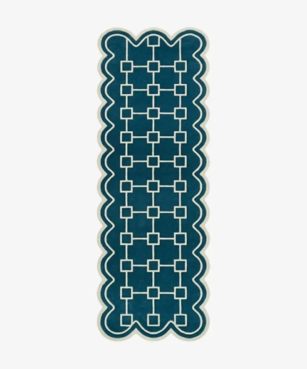 Top down view of the hand-tufted Terenza Coil Runner Rug featuring a rich teal background, a cream geometric square chain pattern, and distinctive scalloped edges.