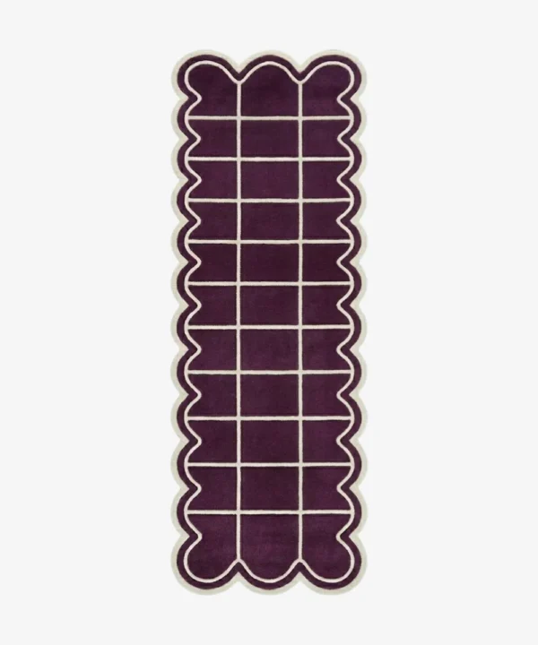 Top-down view of the Velquor Vane runner rug, featuring a rich plum purple background with a crisp cream geometric grid pattern, framed by a deeply contoured wavy cream border.
