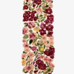 A flat, top-down view of the Cassia Floral Runner Rug isolated on a clean white background. The tufted runner features a vibrant, custom cut-out shape following a dense pattern of pink, burgundy, and purple flowers with green leaves on a cream base.
