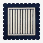 A flat, top-down view of the Coastal Manor Square Rug on a clean white background. The tufted square rug features a classic navy blue and cream vertical striped center, beautifully framed by a thick navy blue scalloped border.