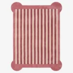 A top-down, flat view of the Rose Candy Stripe Scallop Rug on a clean white background. The tufted rectangular rug features vertical dusty rose and cream stripes, finished with a solid rose-colored border and unique rounded protruding corners.