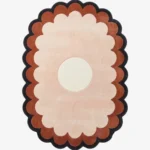 A flat, top-down view of the Sunburst Flower Hand Tufted Wool Rug isolated on a clean white background. The minimalist floral design features a crisp white circular center, surrounded by beautifully tufted, scalloped rings of light pink, terracotta orange, and a dark charcoal grey outer border.