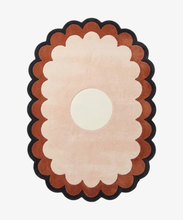 A flat, top-down view of the Sunburst Flower Hand Tufted Wool Rug isolated on a clean white background. The minimalist floral design features a crisp white circular center, surrounded by beautifully tufted, scalloped rings of light pink, terracotta orange, and a dark charcoal grey outer border.