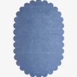 op-down view of the oval Cloud Blue Scalloped Rug isolated on a white background.