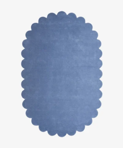 op-down view of the oval Cloud Blue Scalloped Rug isolated on a white background.