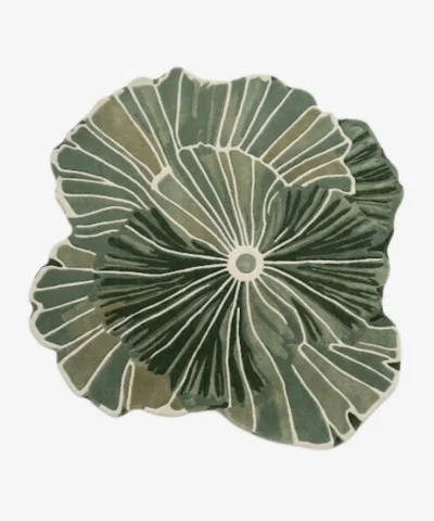 Top-down view of the Green Botanical Irregular rug isolated on a white background, featuring an organic, flowing leaf-like silhouette in solid green and off-white tones.