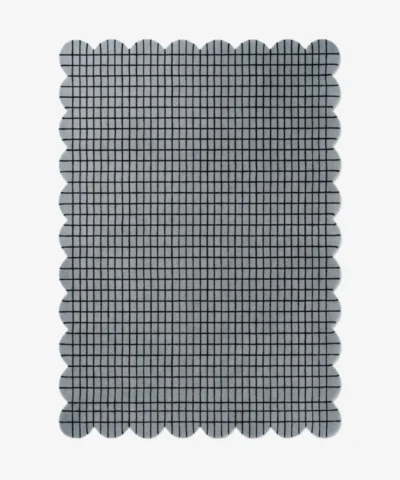 Top-down view of the rectangular Gridline Scalloped Rug featuring a textured gray base with a black check grid pattern.