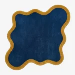 Full top-down view of the Indigo Tide rug isolated on a plain white background, highlighting its custom asymmetrical wavy silhouette.