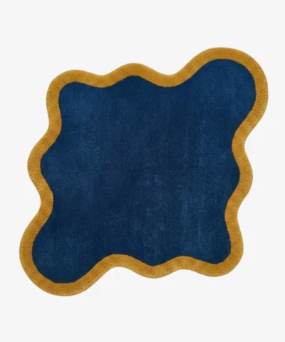 Full top-down view of the Indigo Tide rug isolated on a plain white background, highlighting its custom asymmetrical wavy silhouette.