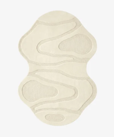 Top-down view of the Ivory Mirage Irregular rug isolated on a white background, featuring a fluid, hourglass-like silhouette with carved organic wave patterns in a solid off-white tone.