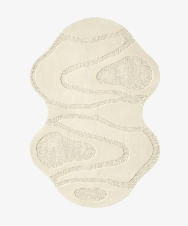 Top-down view of the Ivory Mirage Irregular rug isolated on a white background, featuring a fluid, hourglass-like silhouette with carved organic wave patterns in a solid off-white tone.