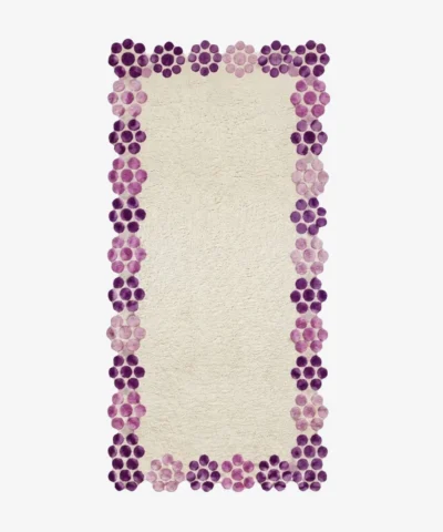 Top-down view of the off-white Petal Dot Runner Rug featuring a scalloped border made of purple and pink tufted circles.