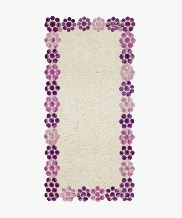 Top-down view of the off-white Petal Dot Runner Rug featuring a scalloped border made of purple and pink tufted circles.