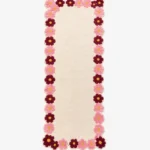 Top-down view of the off-white Petal Frame Runner Rug featuring a decorative border made of pink and burgundy tufted flowers.