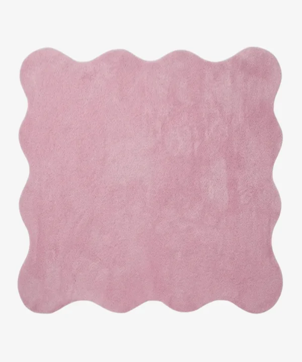 A flat, top-down view of the Roselle Rug isolated on a clean white background. The solid rose pink rug features a playful continuous scalloped border and a decorative carved wavy inner line that elegantly mirrors the outer edge, showcasing its plush hand-tufted texture.